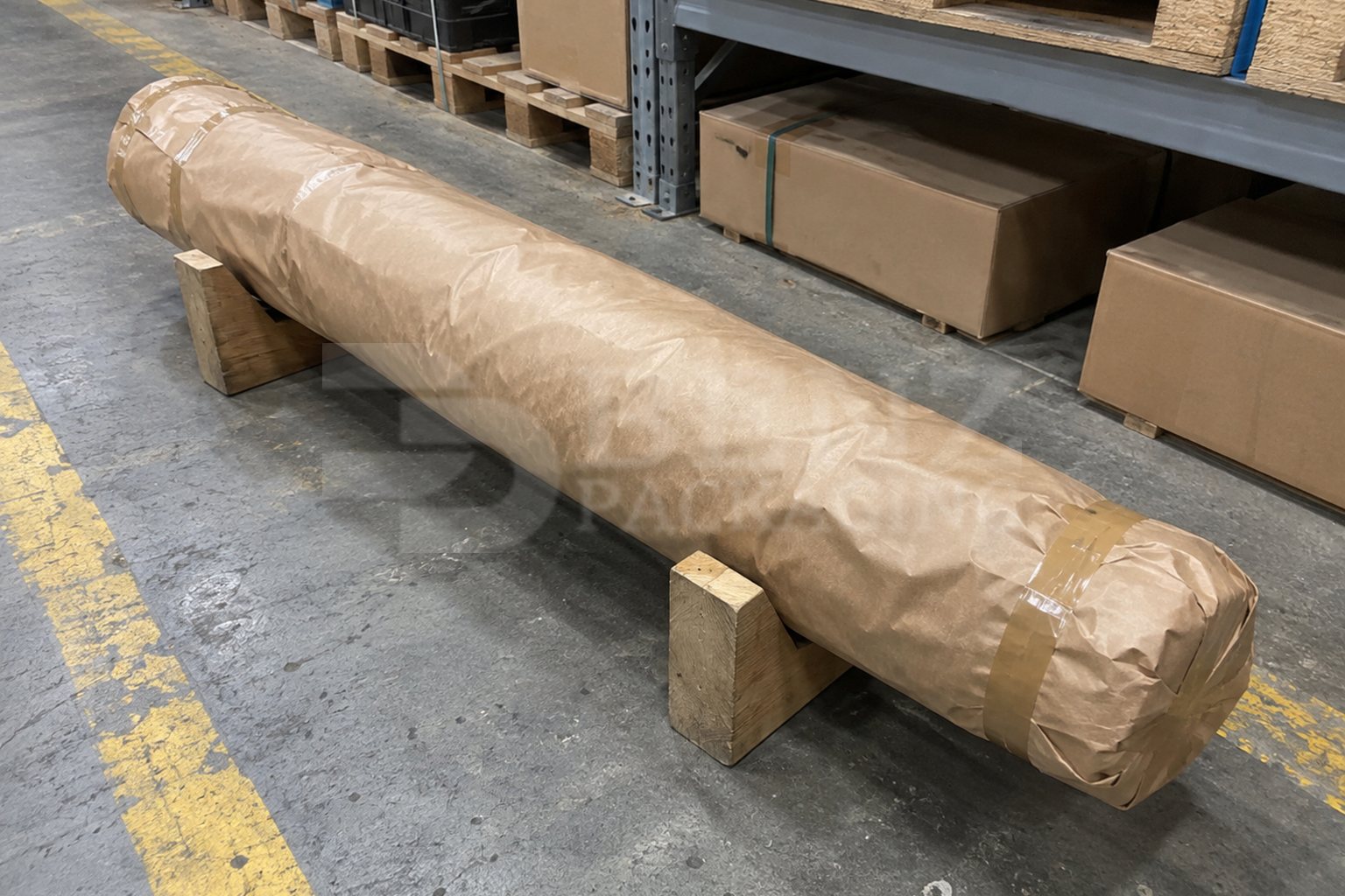 Long drive shaft fully wrapped in brown PE-coated laminated VCI paper