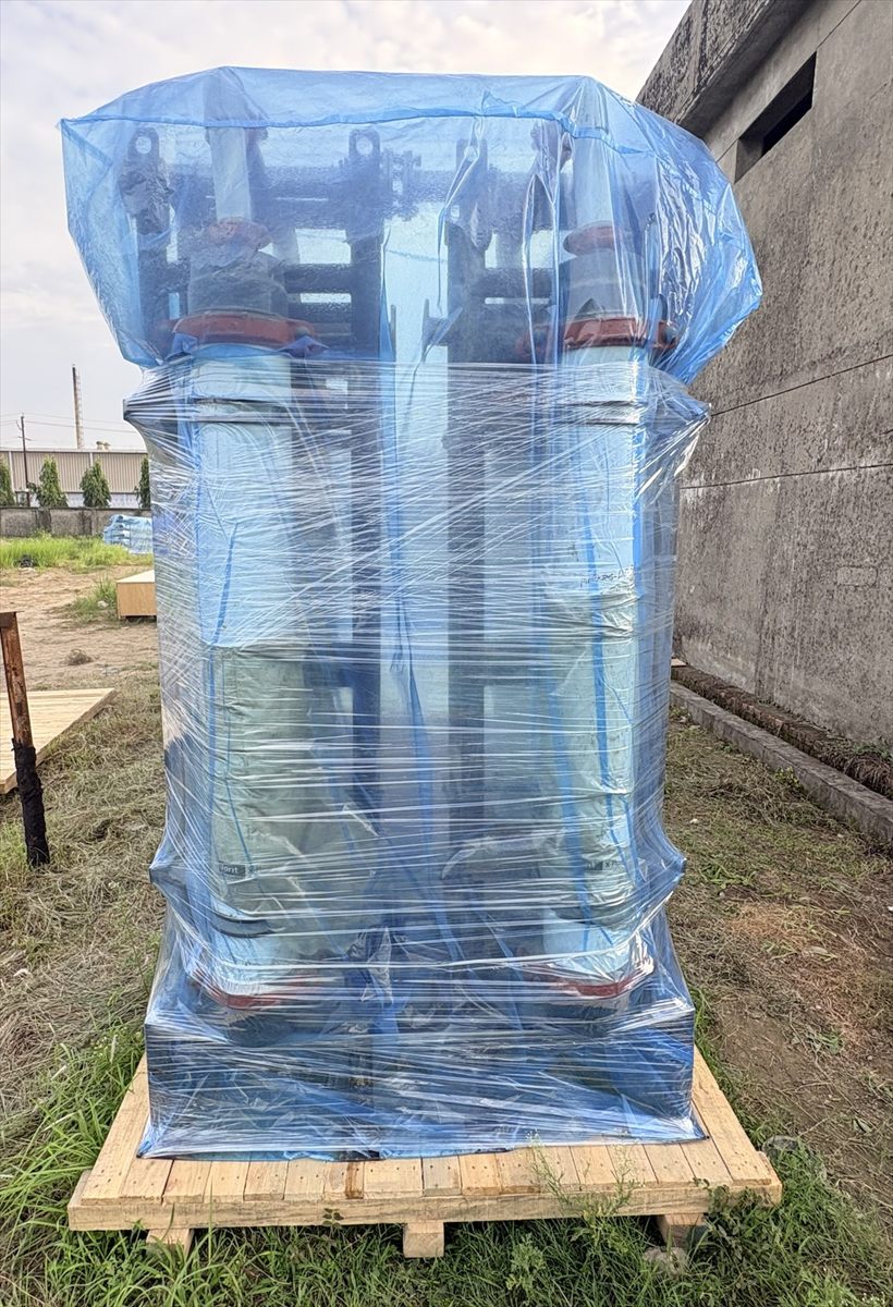 Heat exchanger columns wrapped and secured upright on a shared skid