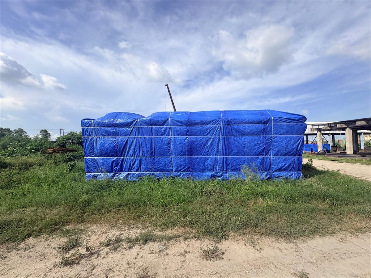 Full weather cover over a large assembly held outdoors before despatch, Bangalore