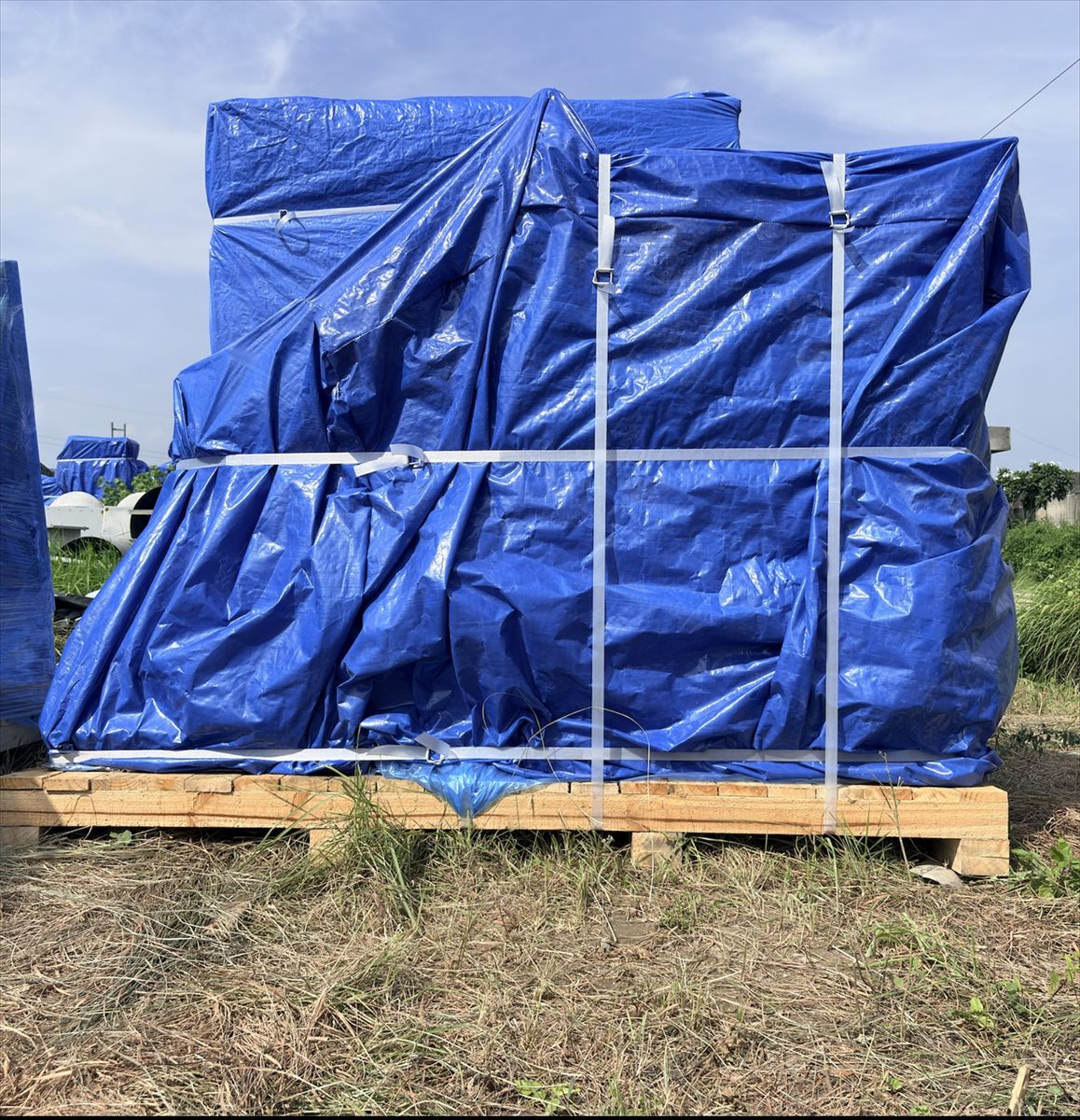 Process equipment tarpaulin wrapped and cross strapped on a timber skid base, Pune