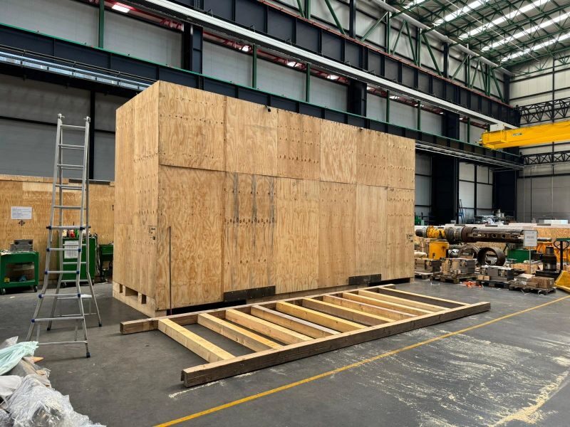 Heavy machine export crate built on load-rated timber skid base