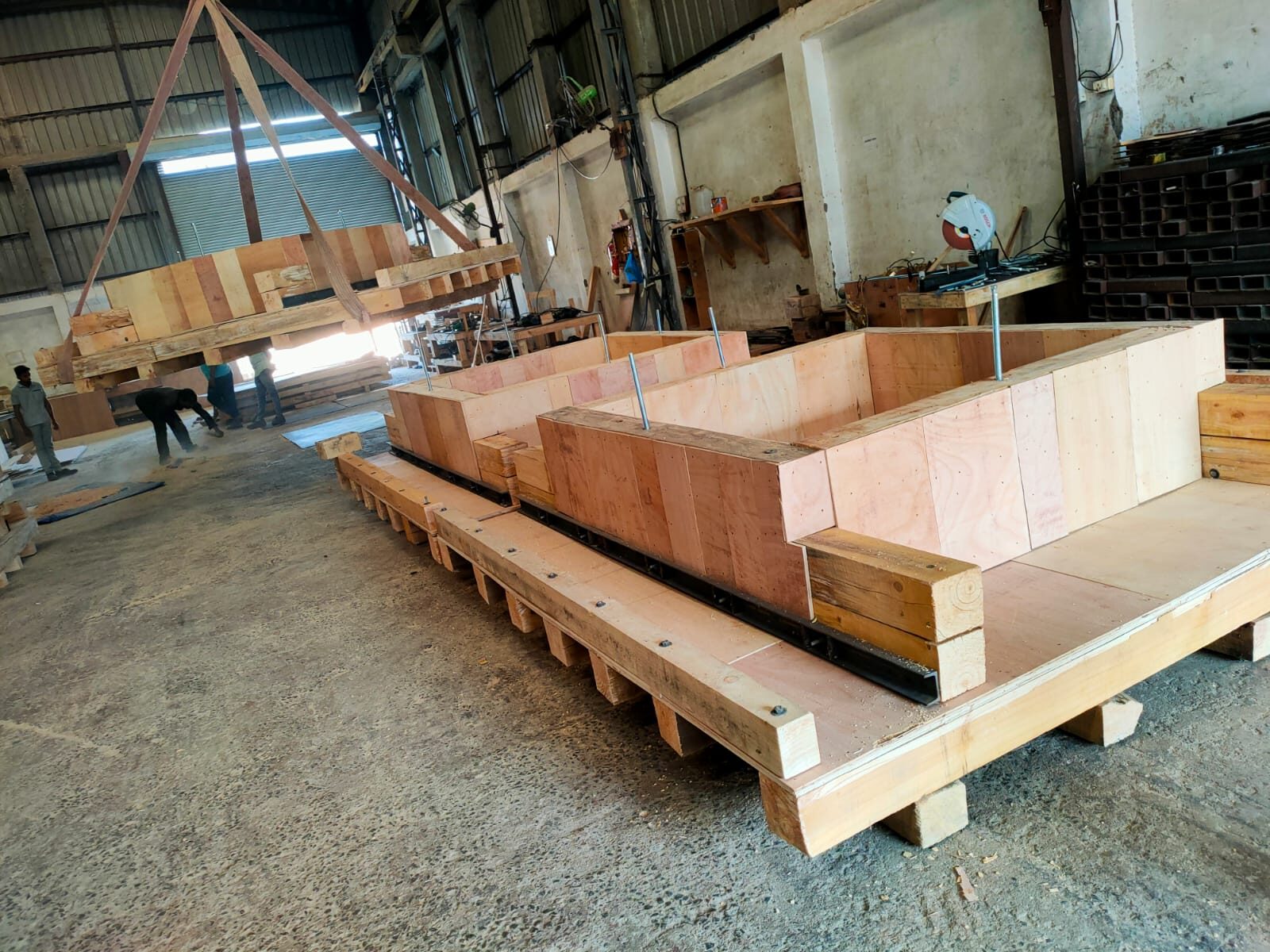 BENZ workshop building a plywood export crate on a timber skid base