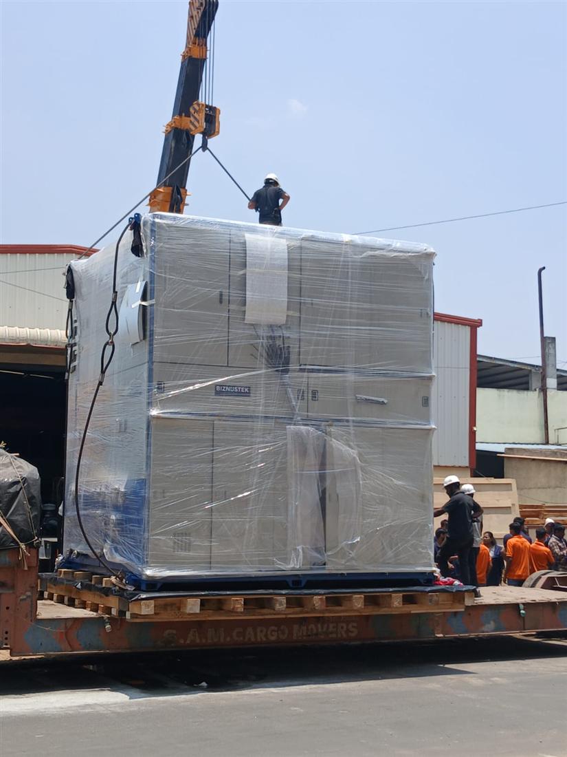 Stretch wrapped machine secured on timber skid loaded onto trailer for export dispatch