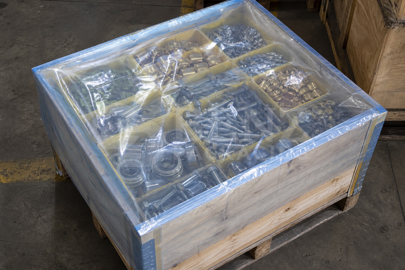Multimetal VCI film packaging for bearings and fasteners inside a pallet box in an industrial parts-protection scenario.