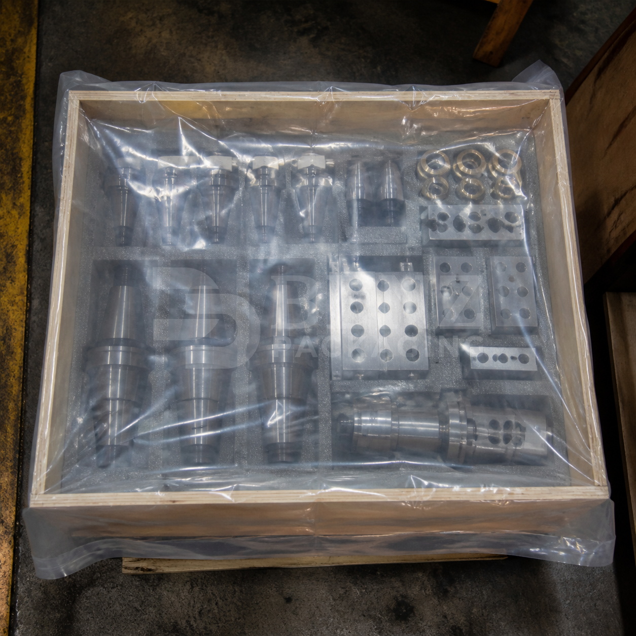Multimetal VCI film packaging for a machine tool toolholder kit inside an export crate in an industrial parts-protection scenario.
