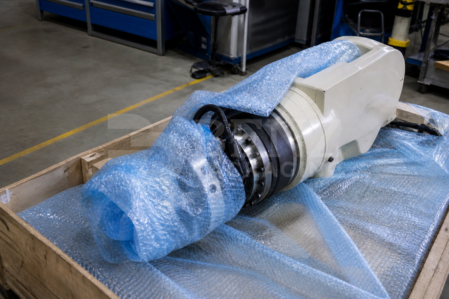 VCI bubble film cushioning a robot wrist assembly in an industrial protective pack.