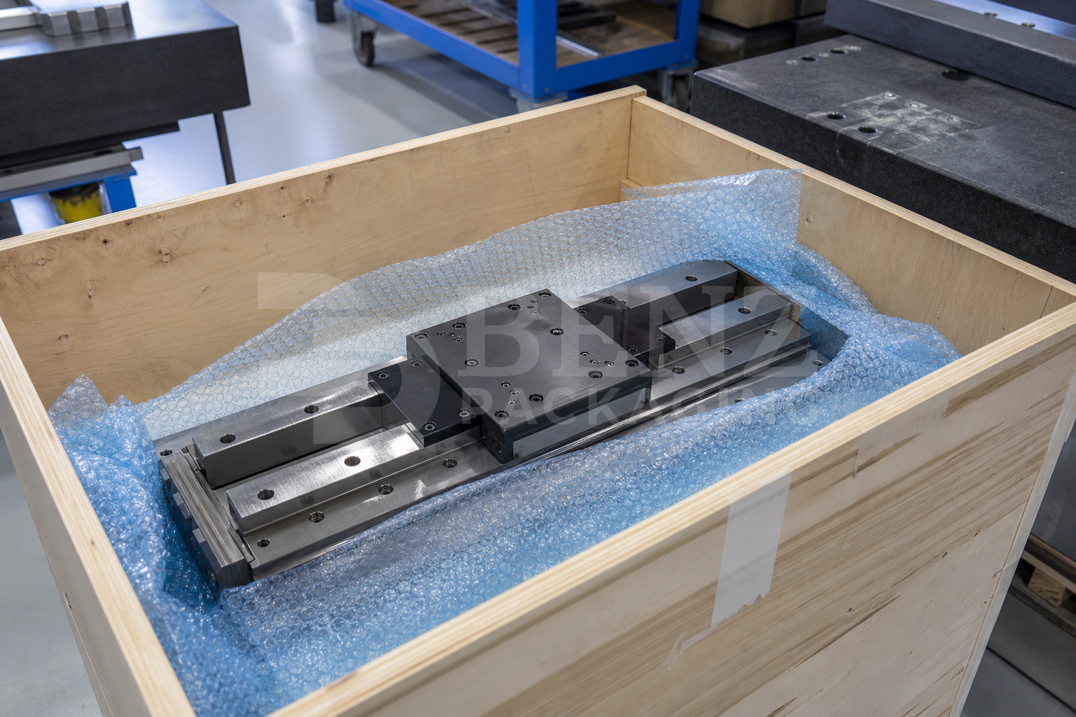VCI bubble film cushioning an optical machine slide in an industrial protective pack.