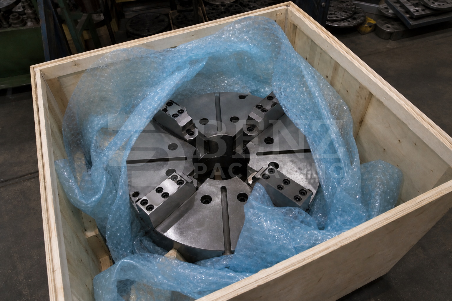 VCI bubble film cushioning a precision lathe chuck in an industrial protective pack.