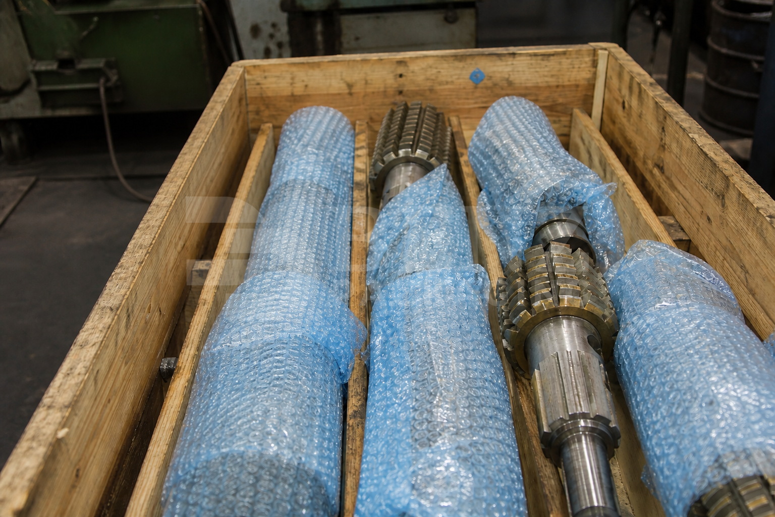 VCI bubble film cushioning gear hobbing arbors in an industrial protective pack.